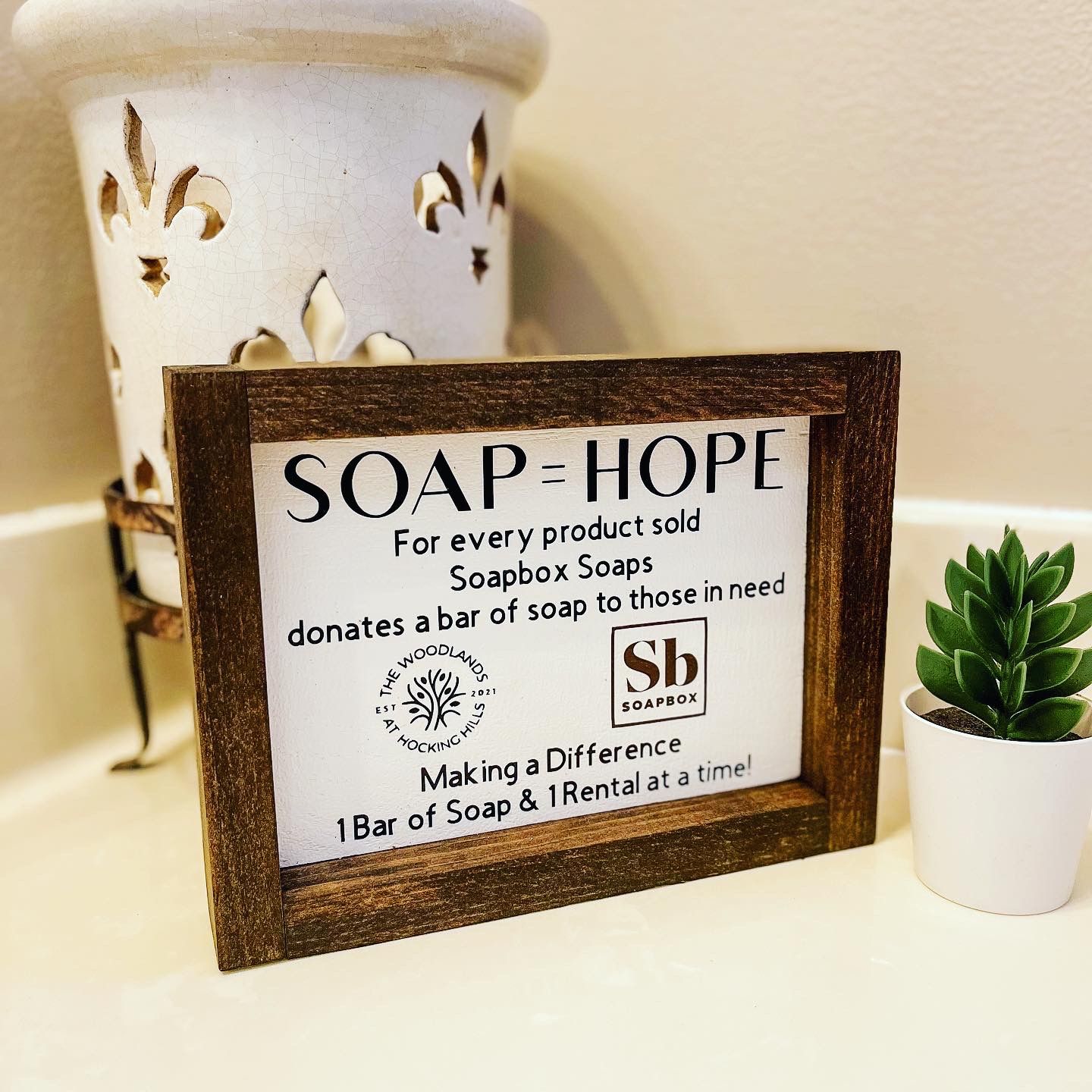 A Soap = Hope sign in a host's bathroom sharing the impact of every product sold