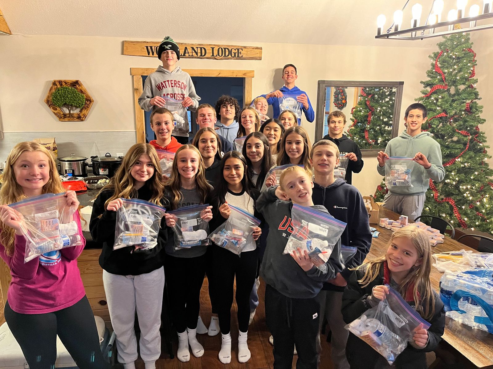Group of young volunteers holding blessing bags they assembled