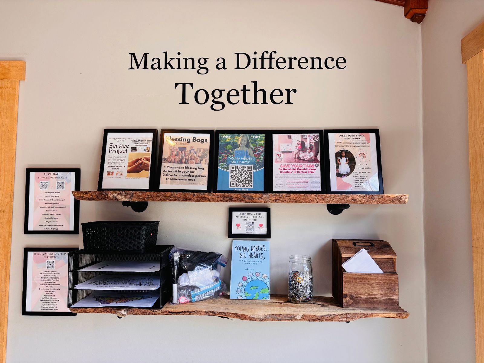 A 'Making a Difference Together' display wall featuring service projects, Blessing Bags, and organizations supported